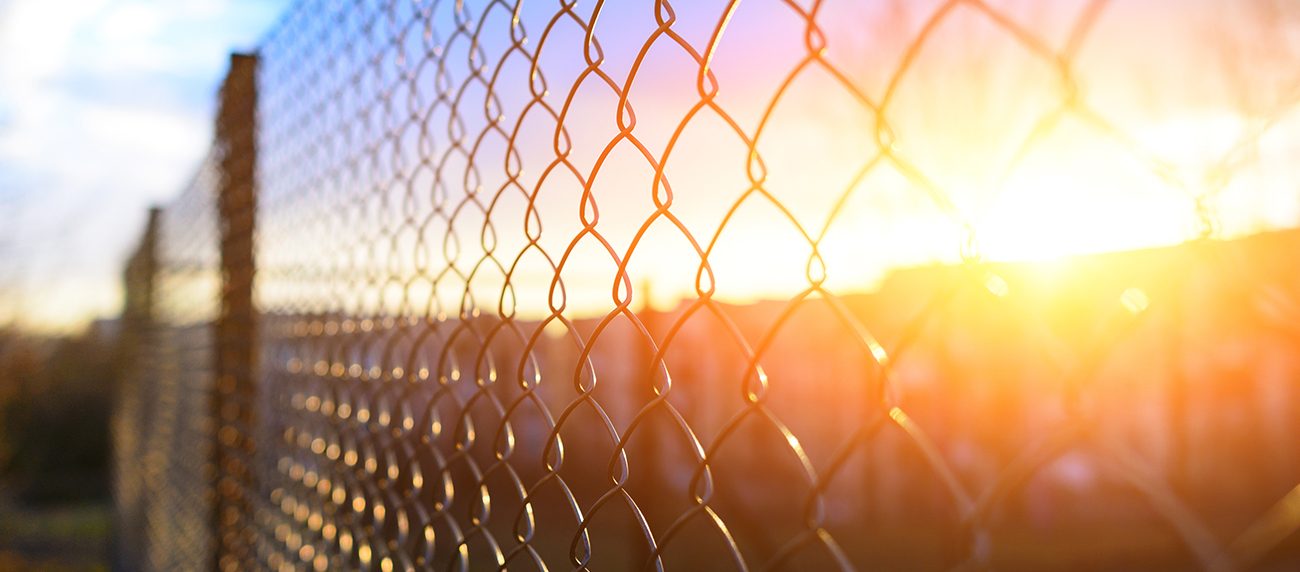 Chain link fence at sunset